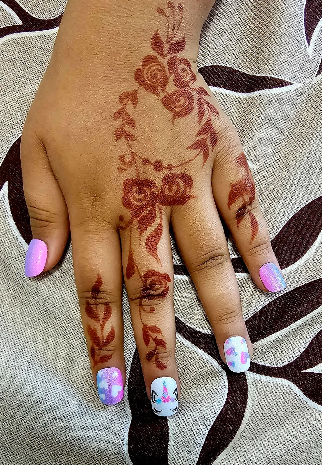 Nail art and henna on a client's hand