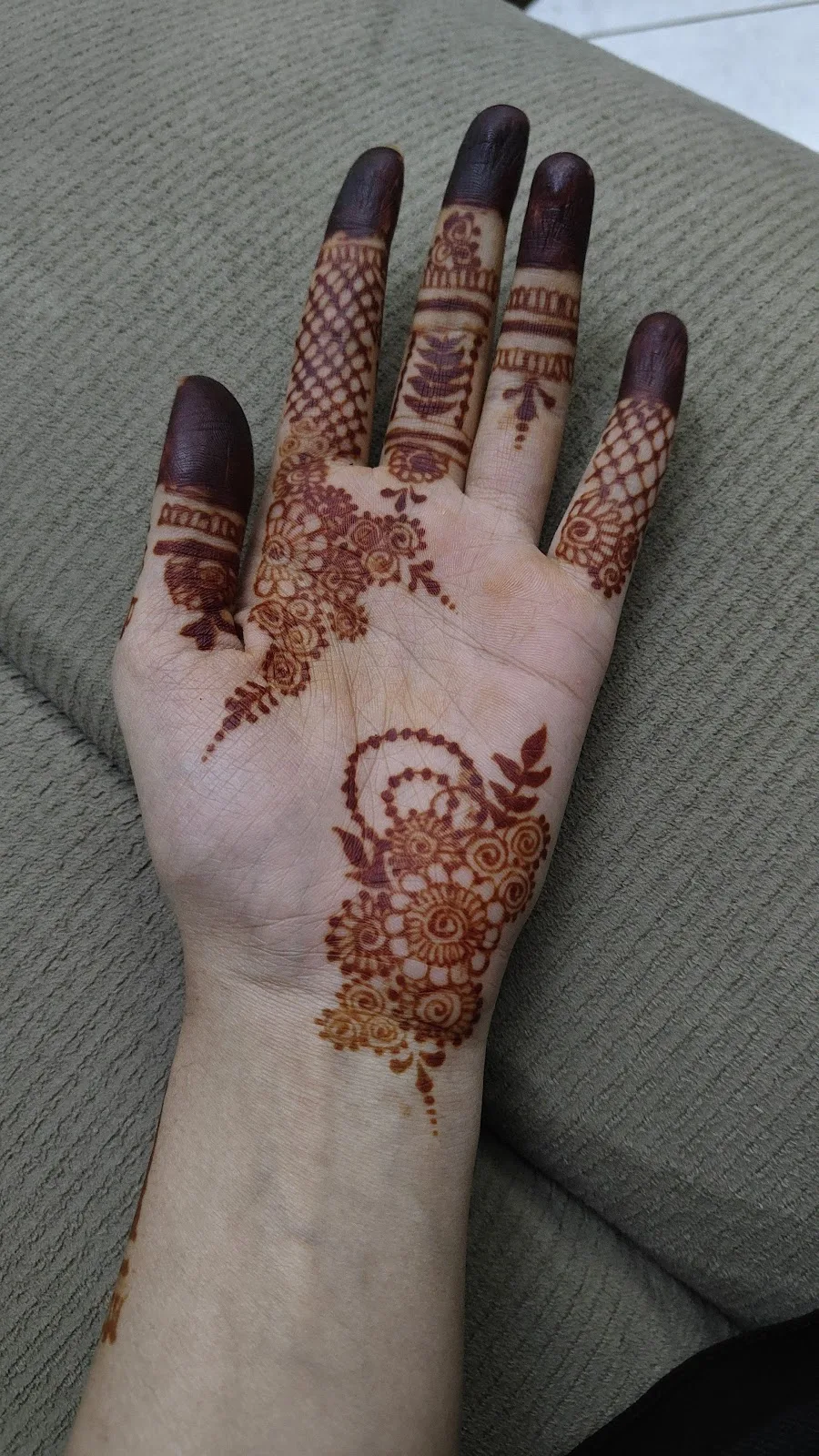 Detailed henna mehndi design on a palm at Nouveau Beauty Salon