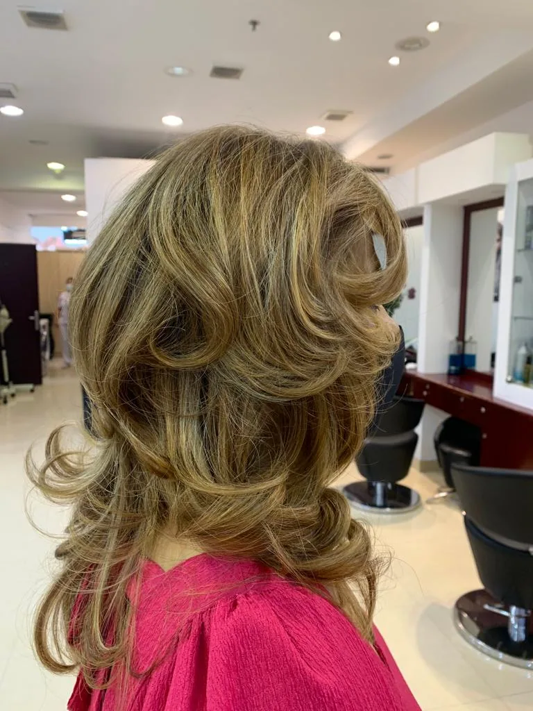 A voluminous, layered blow-dry styled at the salon