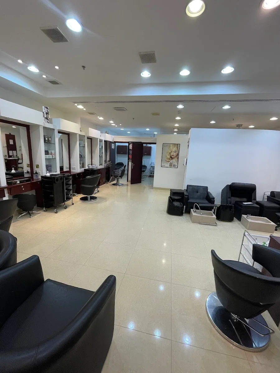 The bright, spacious styling floor at Déjà Vu Beauty Salon with mirror stations and a lounge area