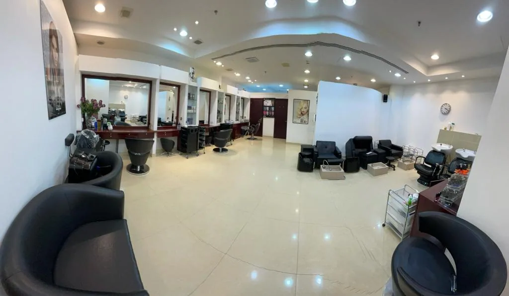 A wide view of the salon's mirrors, chairs and lounge