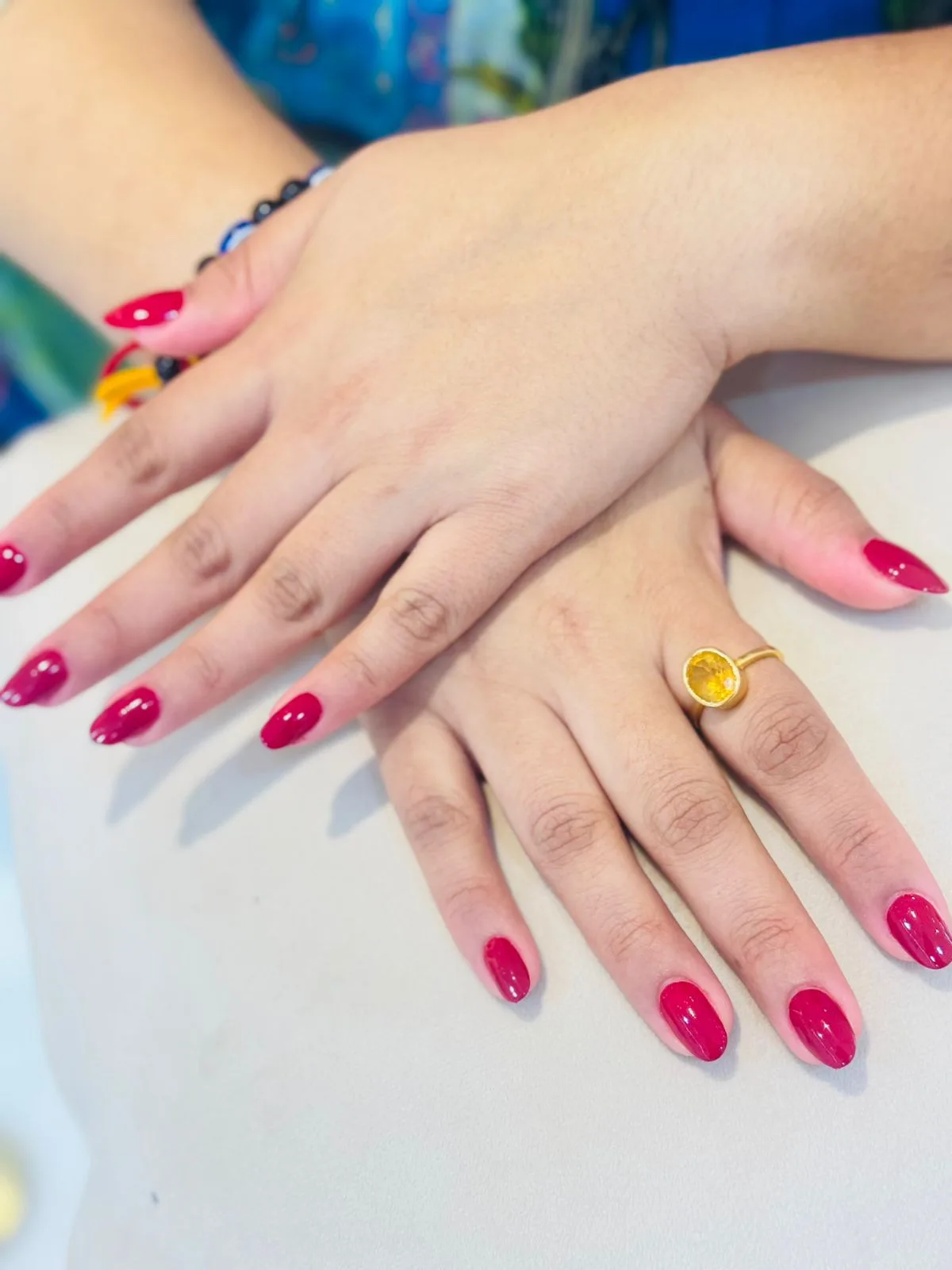 Deep red gel manicure finished at Elegant Essence