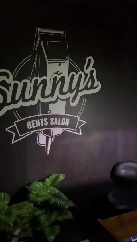 Sunny's Gents Salon clipper logo painted on the salon wall
