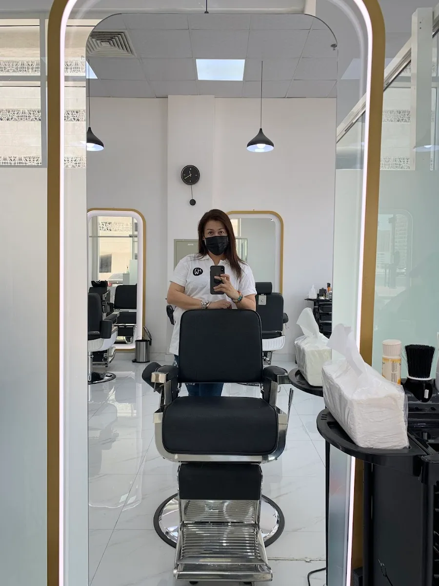 Barber chair and arched LED mirrors inside Sunny's Evershine Gents Salon