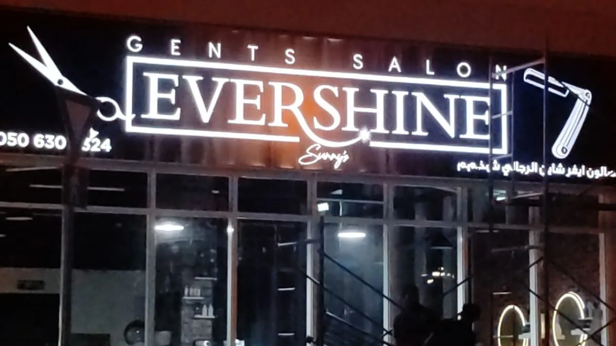 Evershine Gents Salon illuminated storefront sign at night in Al Nahda, Dubai