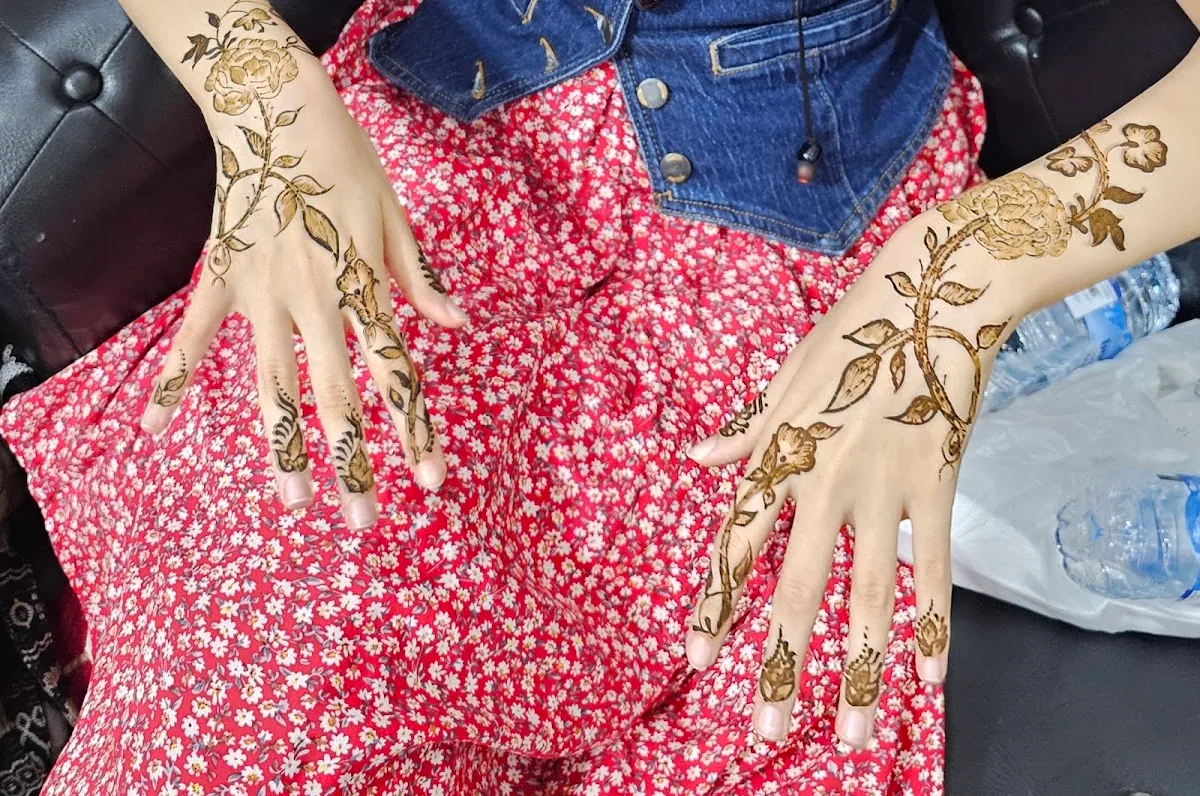 Detailed floral henna applied to a guest's hands at Al Yaqota Aljameela
