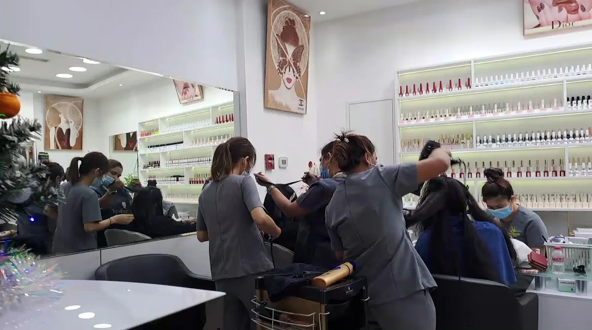 Interior of Huyen Nguyen Beauty Salon with technicians styling clients' hair