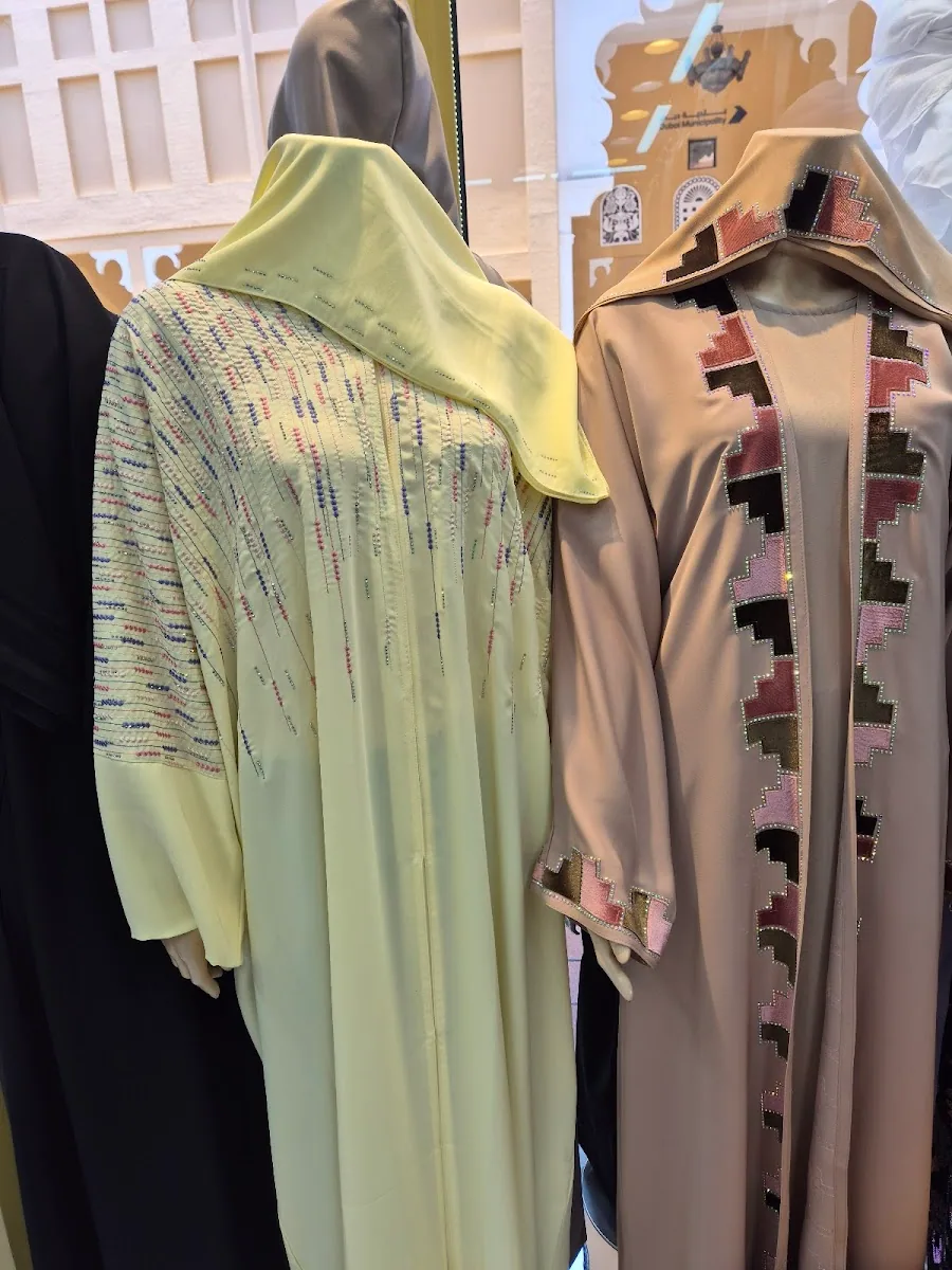Soft yellow abaya and a sand abaya with stepped colour appliqué