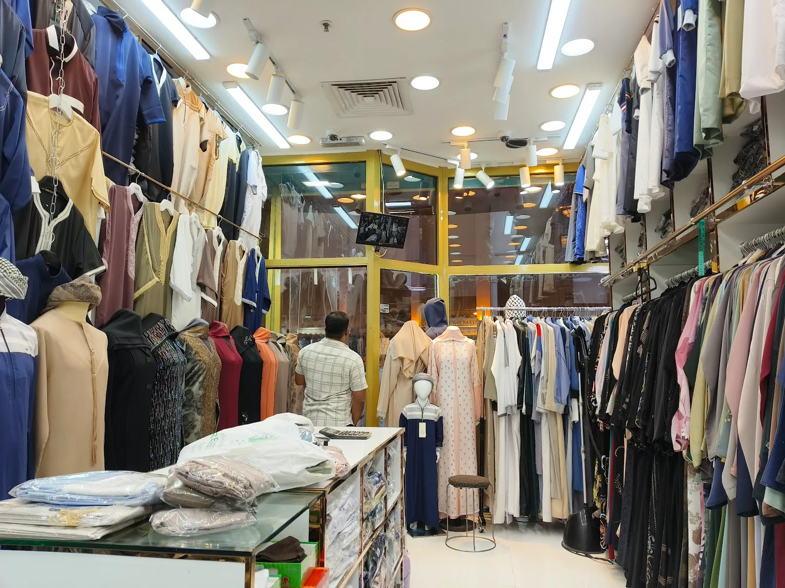 Inside Top Naif Abaya Trading — rails of abayas and traditional wear