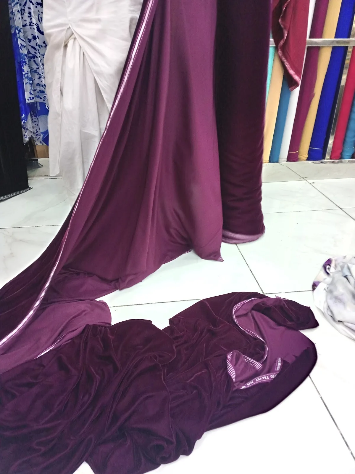 Lengths of deep plum fabric draped in store