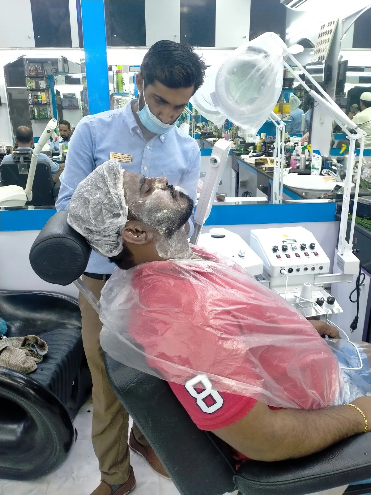 A client receiving a facial treatment in the salon chair