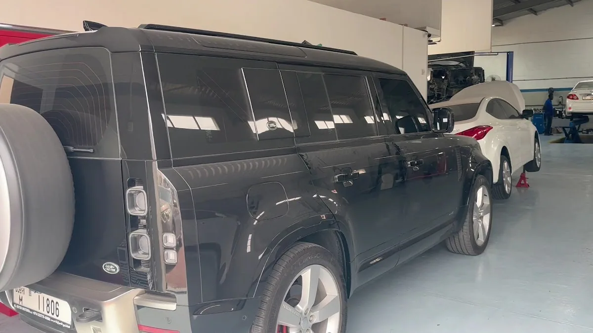 Black Land Rover Defender in the service bay