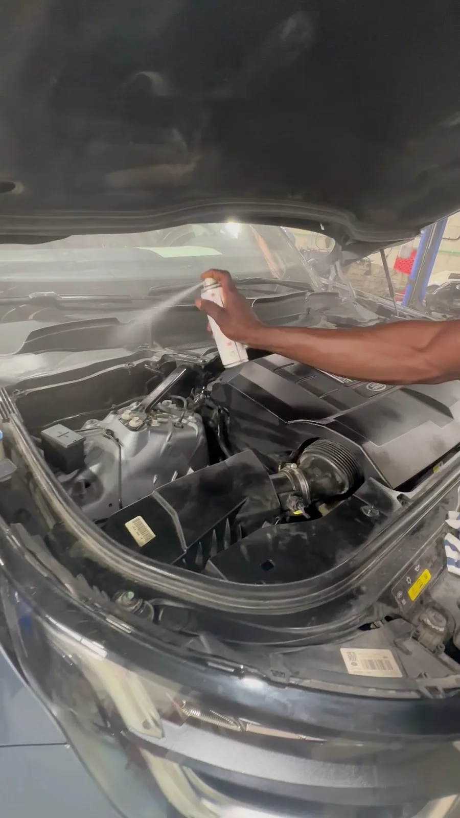 Technician servicing an engine bay at Auto Craft Garage