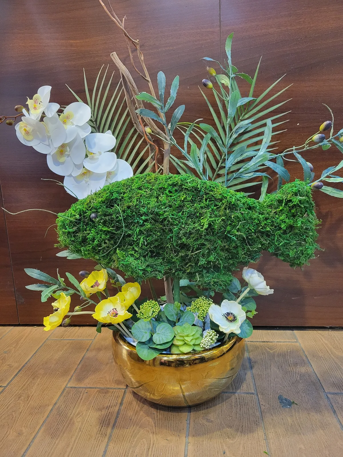 Bespoke moss and orchid sculptural arrangement in a gold bowl
