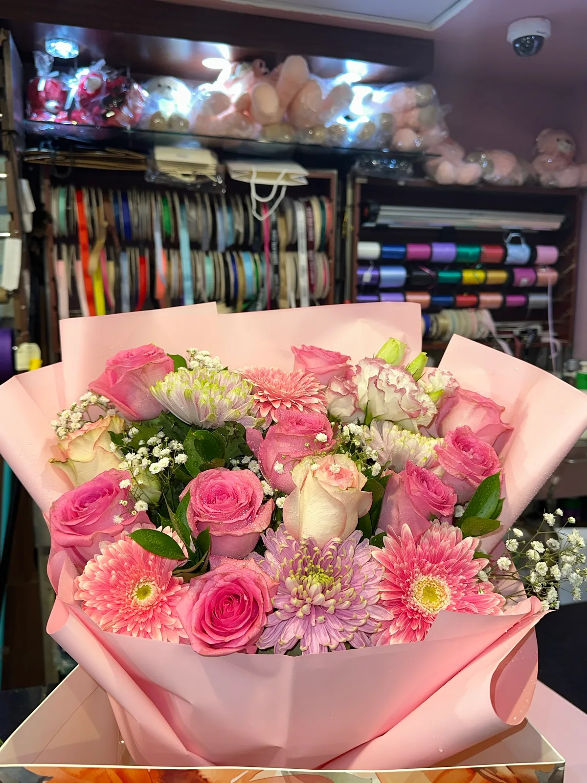 Pink rose and gerbera bouquet wrapped in soft pink paper
