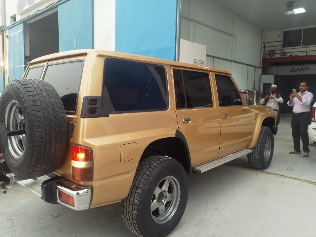 Restored gold Nissan Patrol after bodywork at Muhammad Asghar Garage