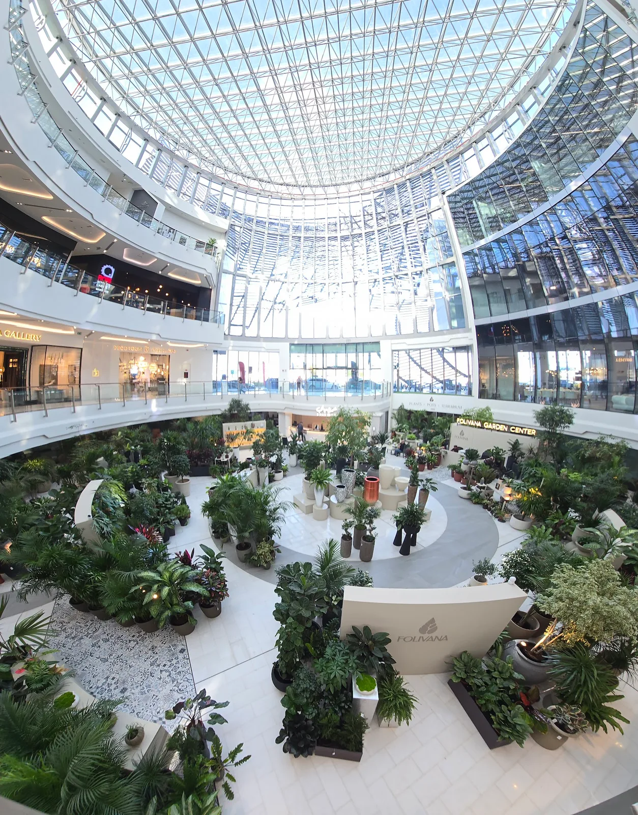 The Folivana Garden Center plant atrium under a large glass dome inside Art of Living Mall, Dubai