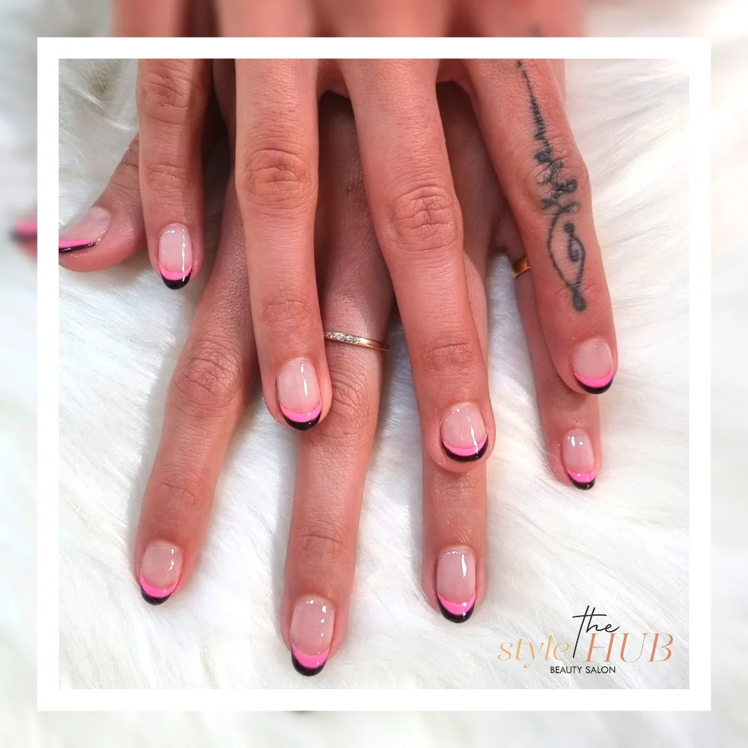 Pink and black French-tip nail art done at the salon