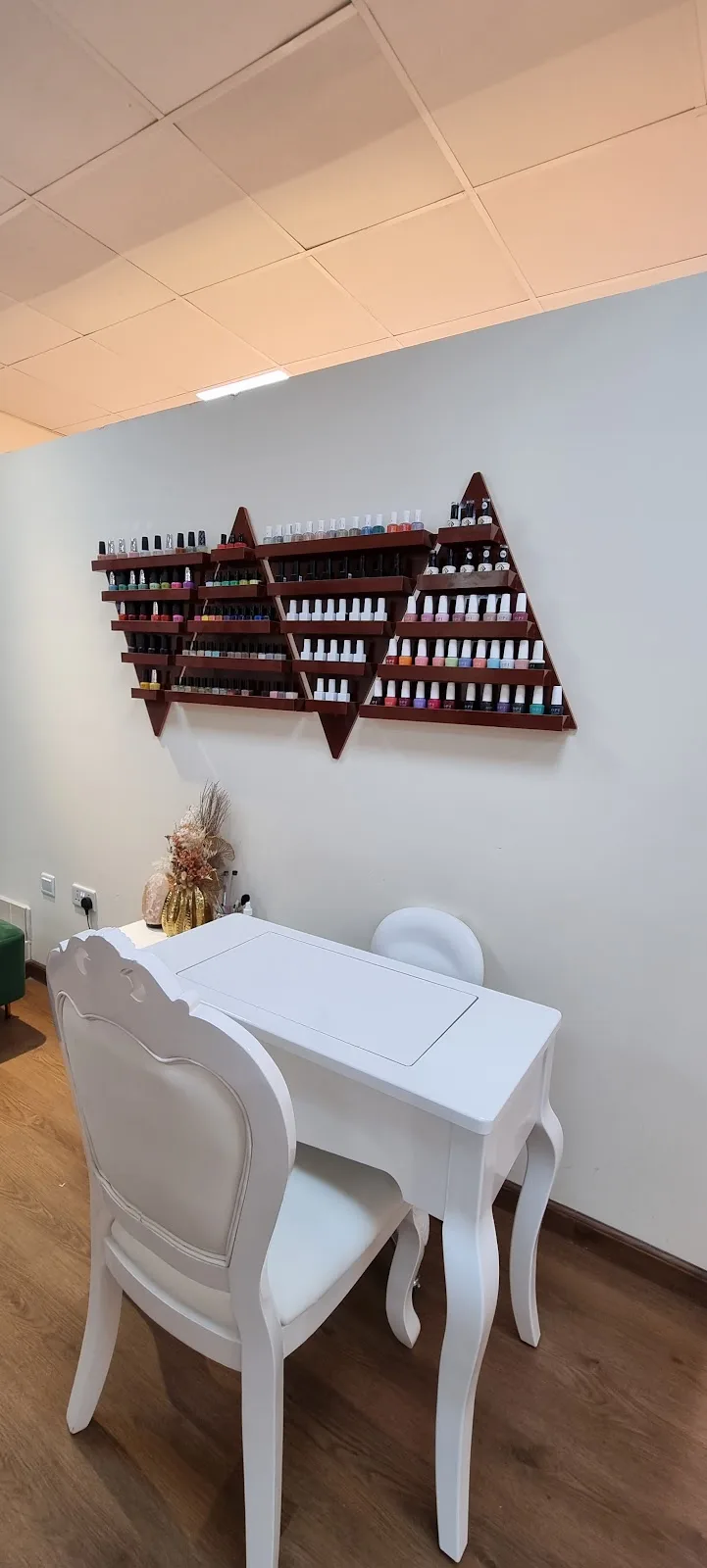 Manicure table and a wall of colourful nail polishes