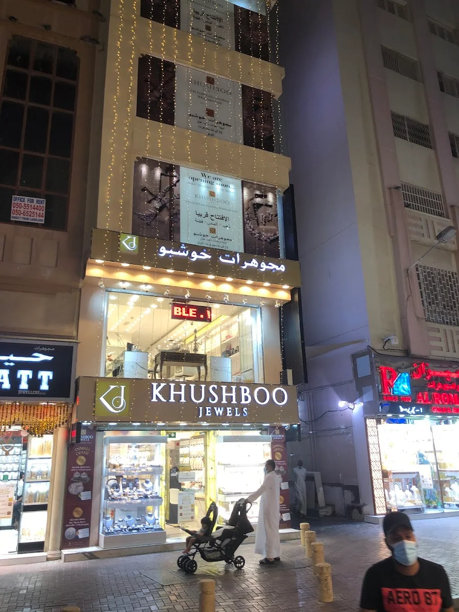 Khushboo Jewels storefront lit up at night in the Deira Gold Souk, Dubai