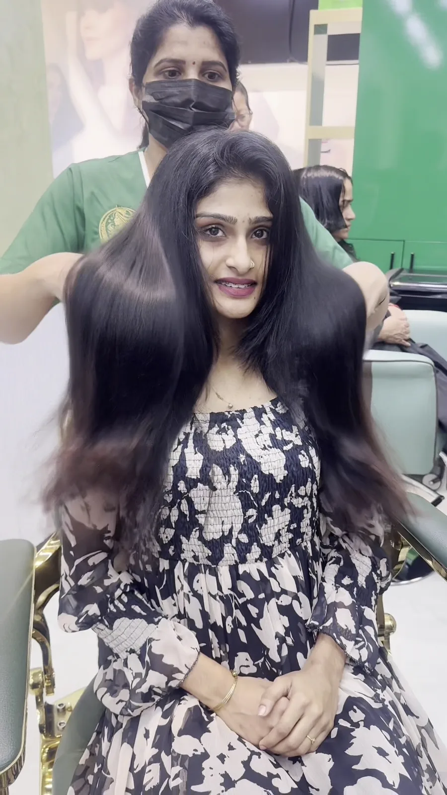 Long, glossy hair styled by a stylist at the salon