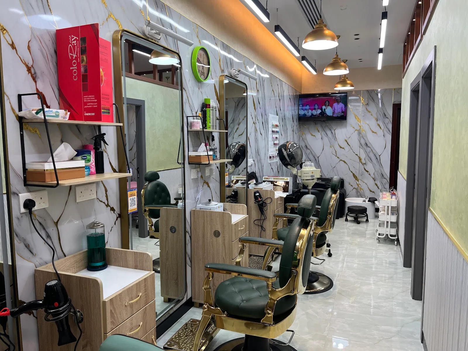 Hair colour and styling station with gold mirrors and marble walls