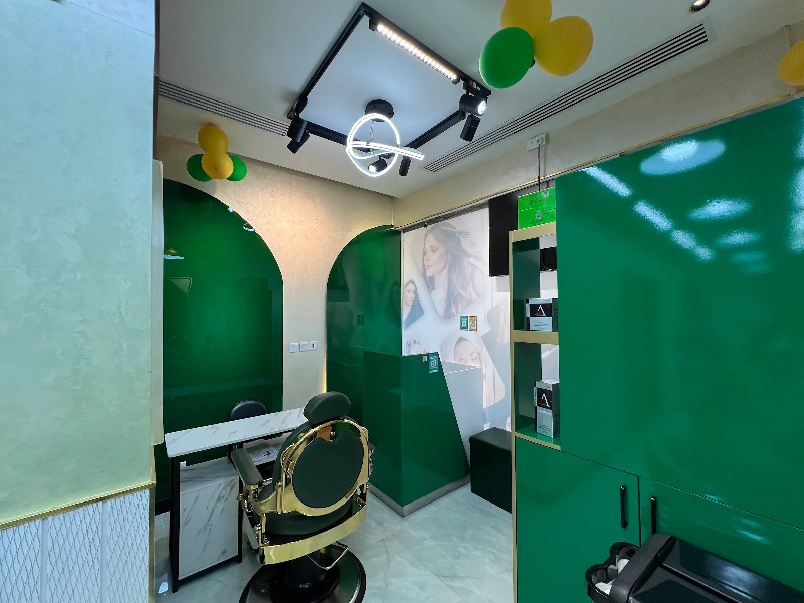 Emerald arch alcoves and gold styling chair inside Haya Beauty Lounge
