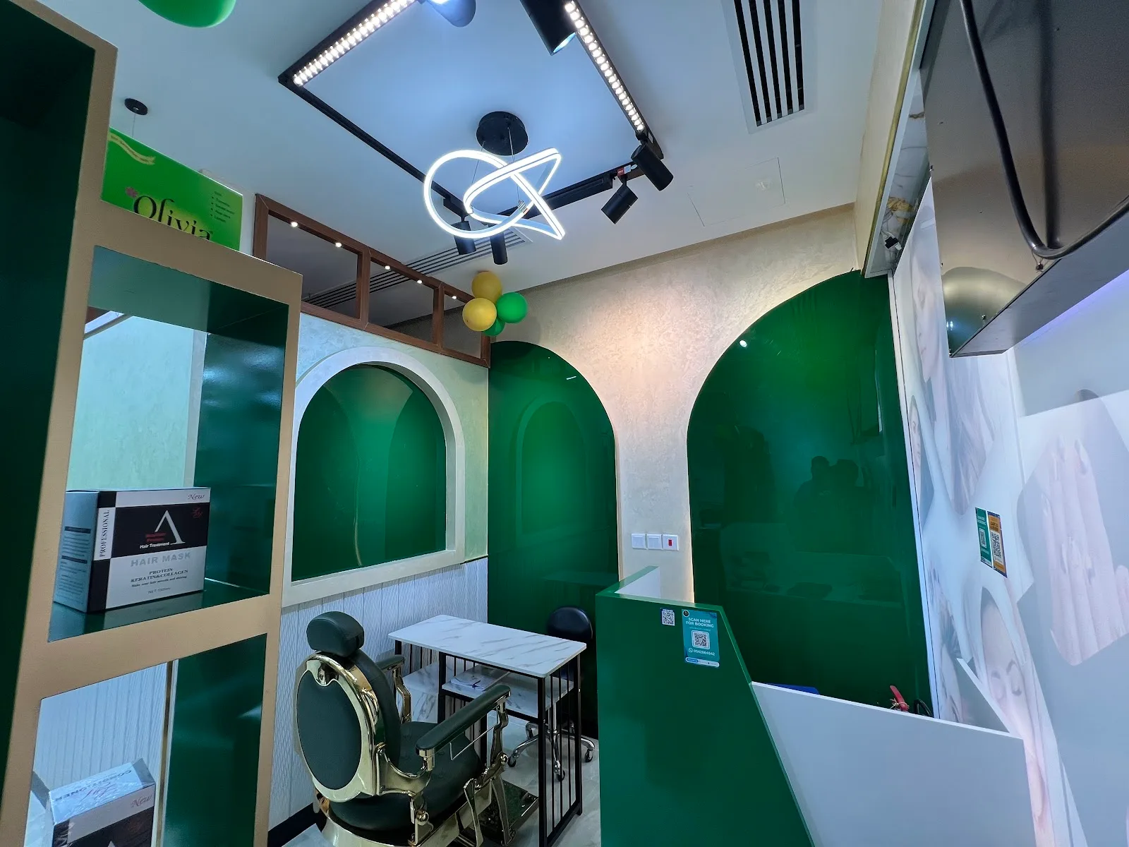 Signature emerald arches and gold detailing inside Haya Beauty Lounge