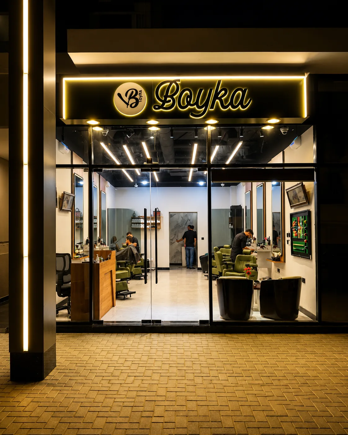 BOYKA Gents Salon storefront lit up at night in Jumeirah Village Circle, Dubai