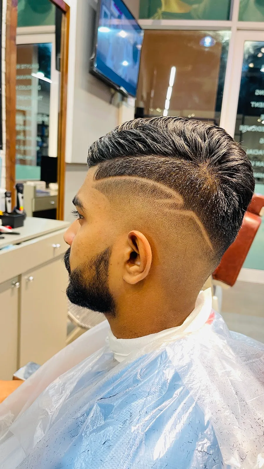 Detailed side fade with hair design and shaped beard at H&B Gents Salon
