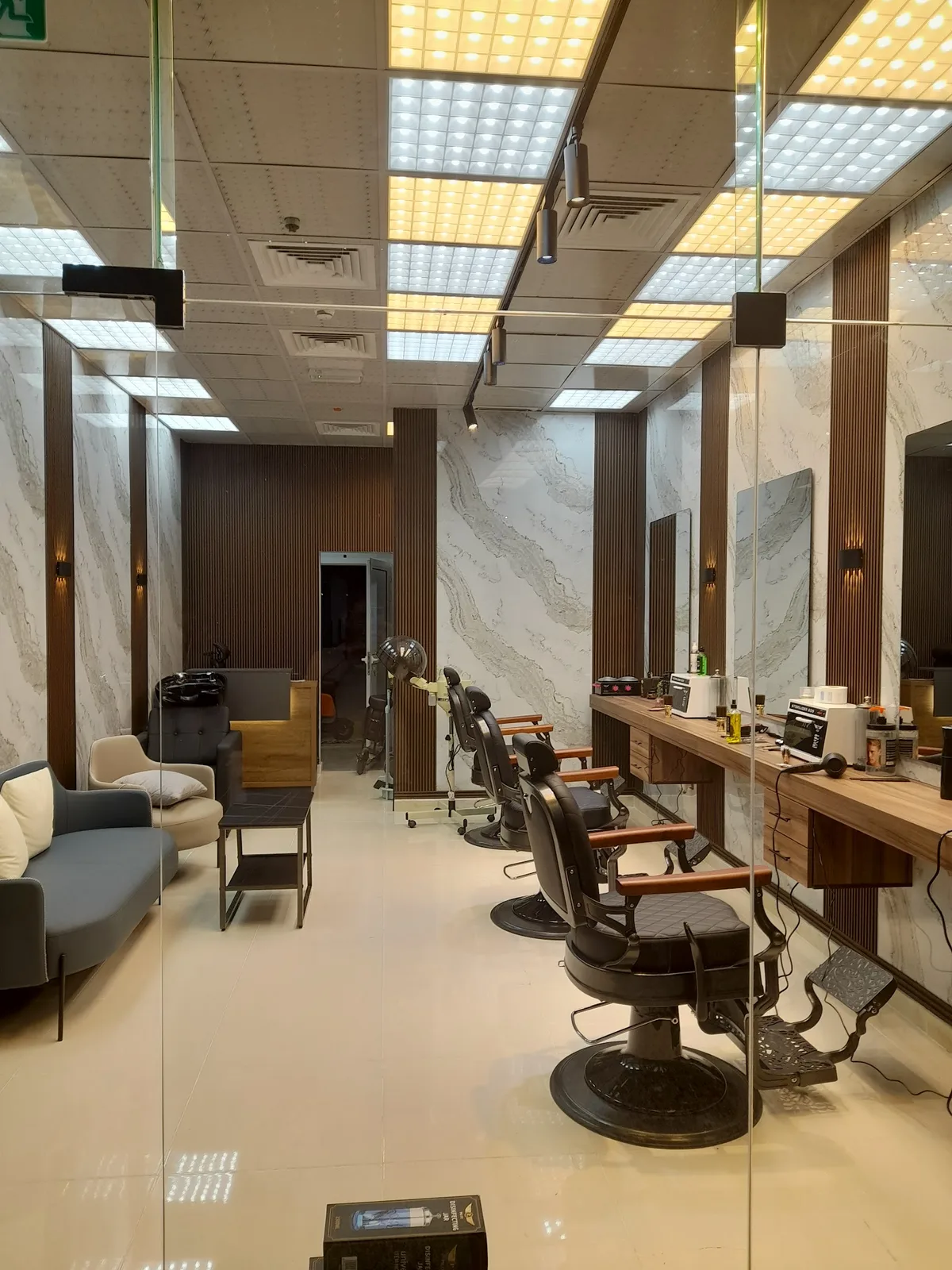 Marble walls, walnut panelling and classic barber chairs inside Adam Barber Turkish Salon
