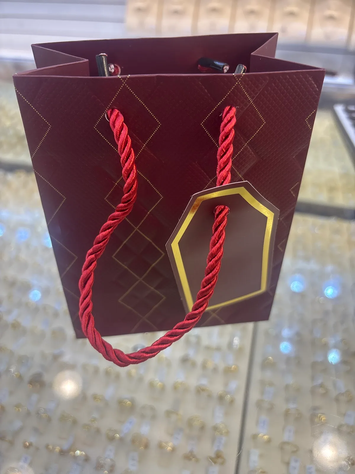 Evora Gold maroon and gold gift bag with diamond lattice pattern