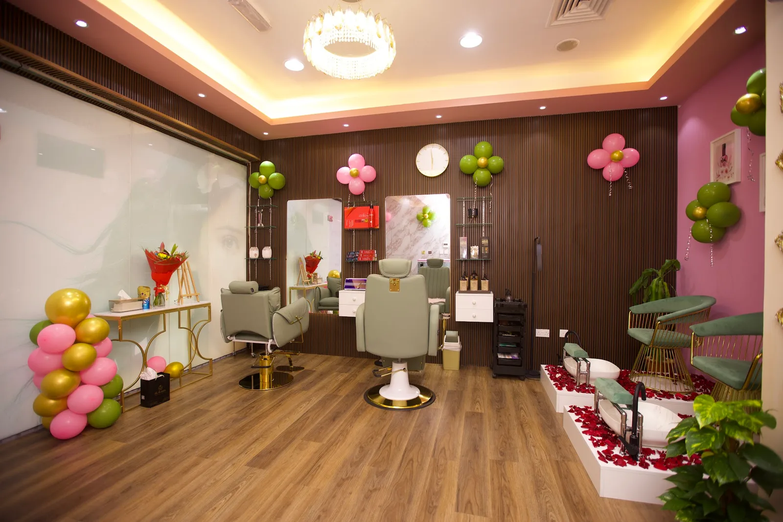 Styling chairs and pedicure stations at Pure Bliss with green and gold accents
