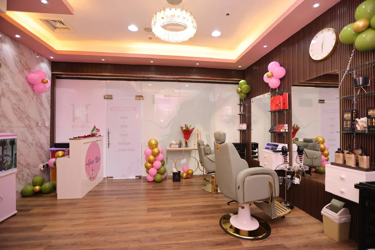 Interior of Pure Bliss Beauty Salon with styling chairs, mirrors and floral décor