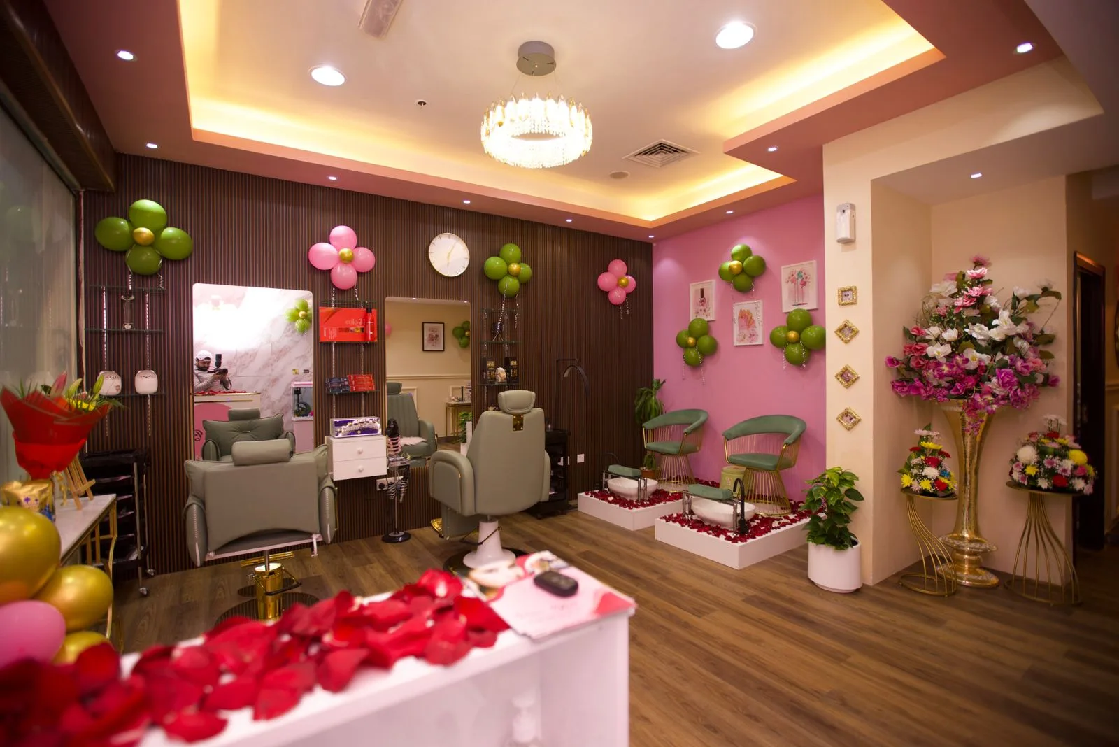 Wide view of Pure Bliss salon showing pedicure stations, styling area and floral displays