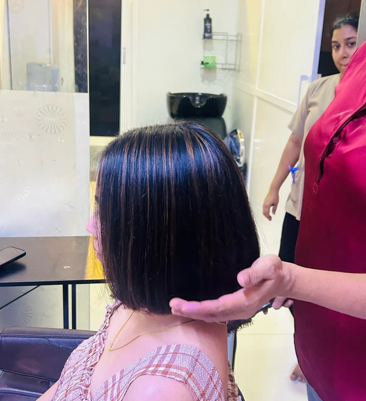 Chin-length bob with subtle highlights, side view