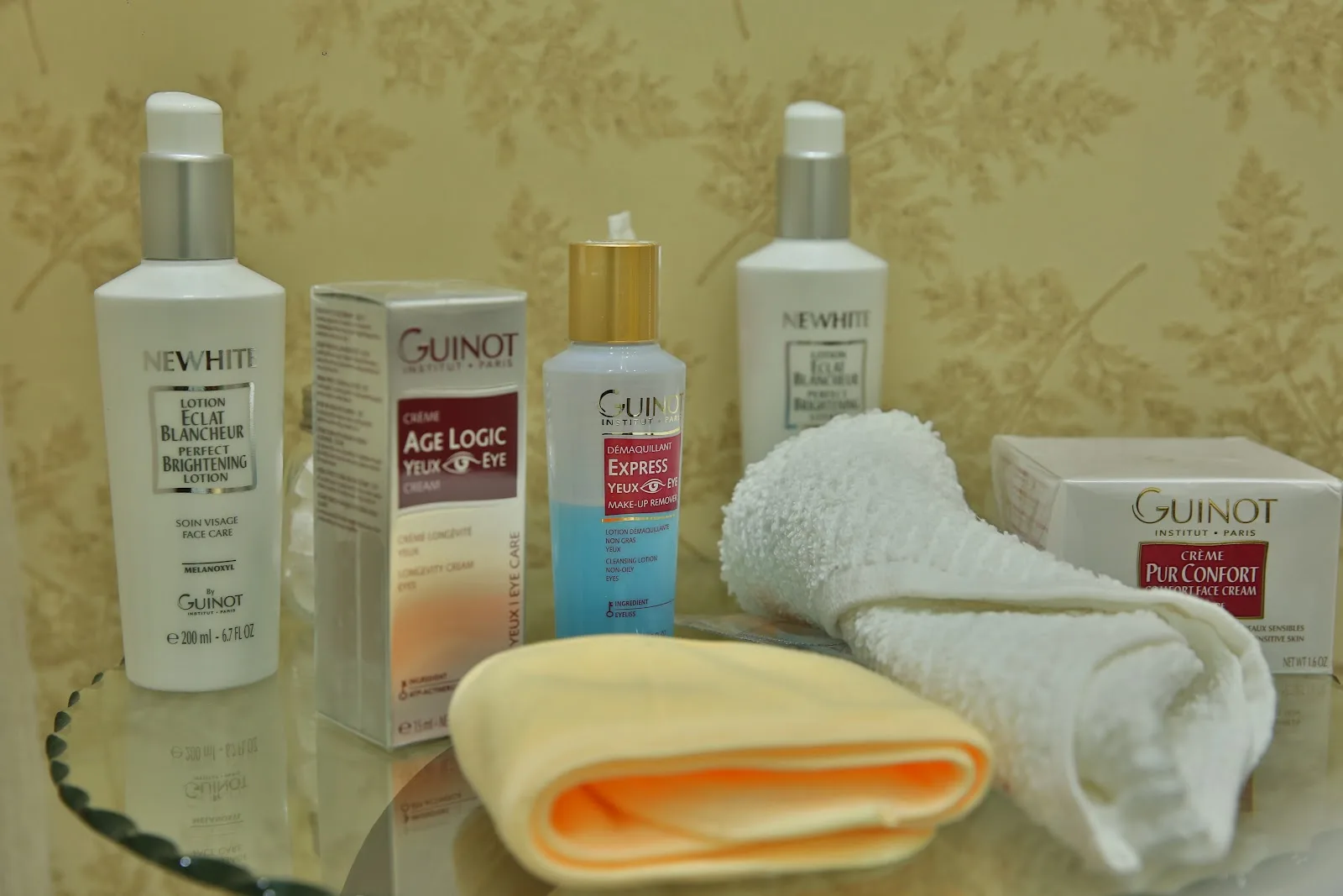 Professional facial skincare products arranged on a mirrored tray