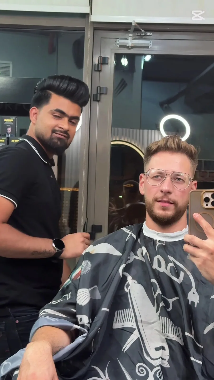 A client showing a fresh haircut and beard trim in the chair at The Boss Gents Salon, Al Satwa