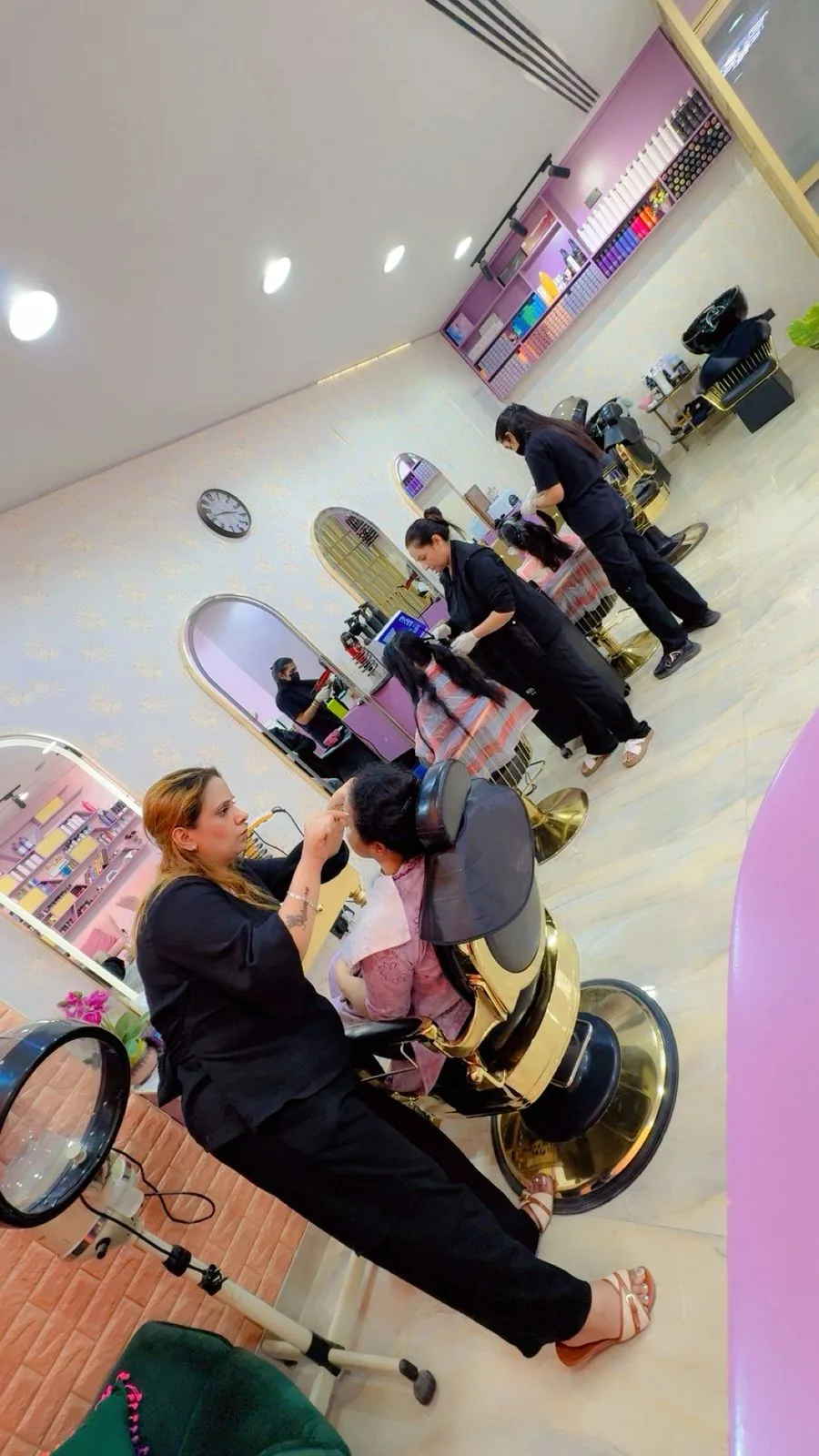 Stylists attending to clients at the mirror stations