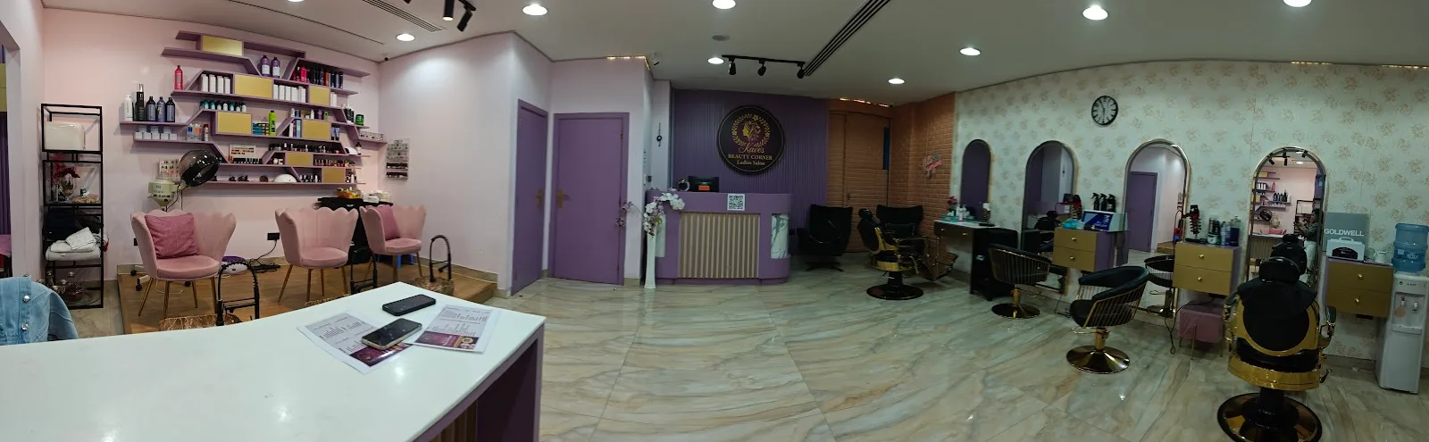 Panorama of the salon floor with styling stations and waiting lounge