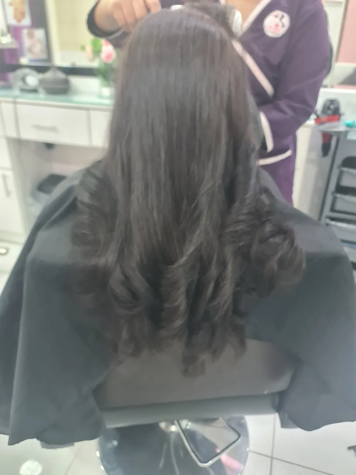 Glossy blow-dry with bouncy curls, finished at the styling chair