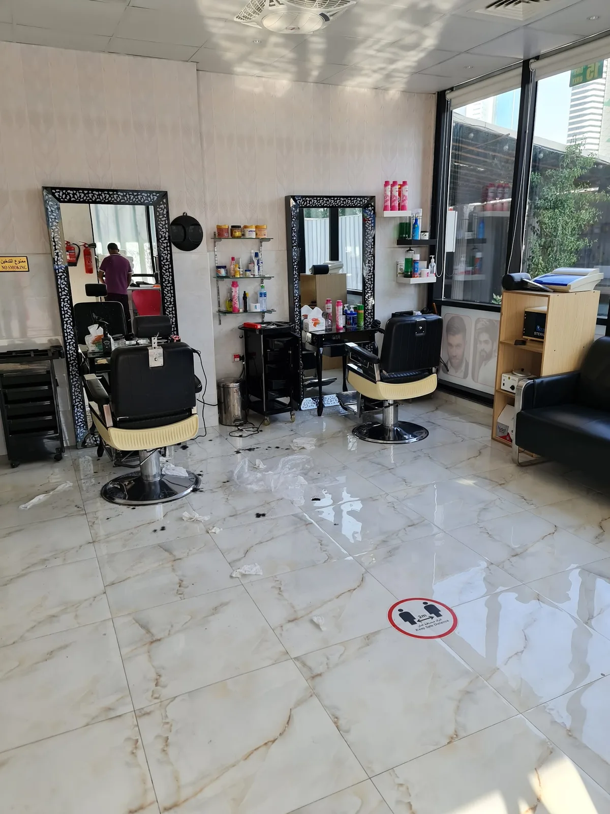 Marble-floored interior of Babul Shil Gents Saloon with classic barber chairs and cut-out framed mirrors