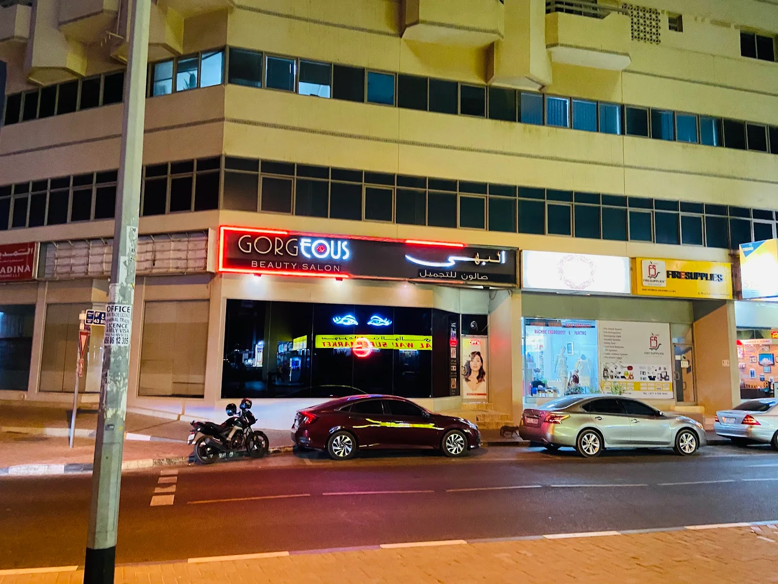 Wide view of Gorgeous Beauty Saloon storefront and neon sign on the street in Hor Al Anz, Deira