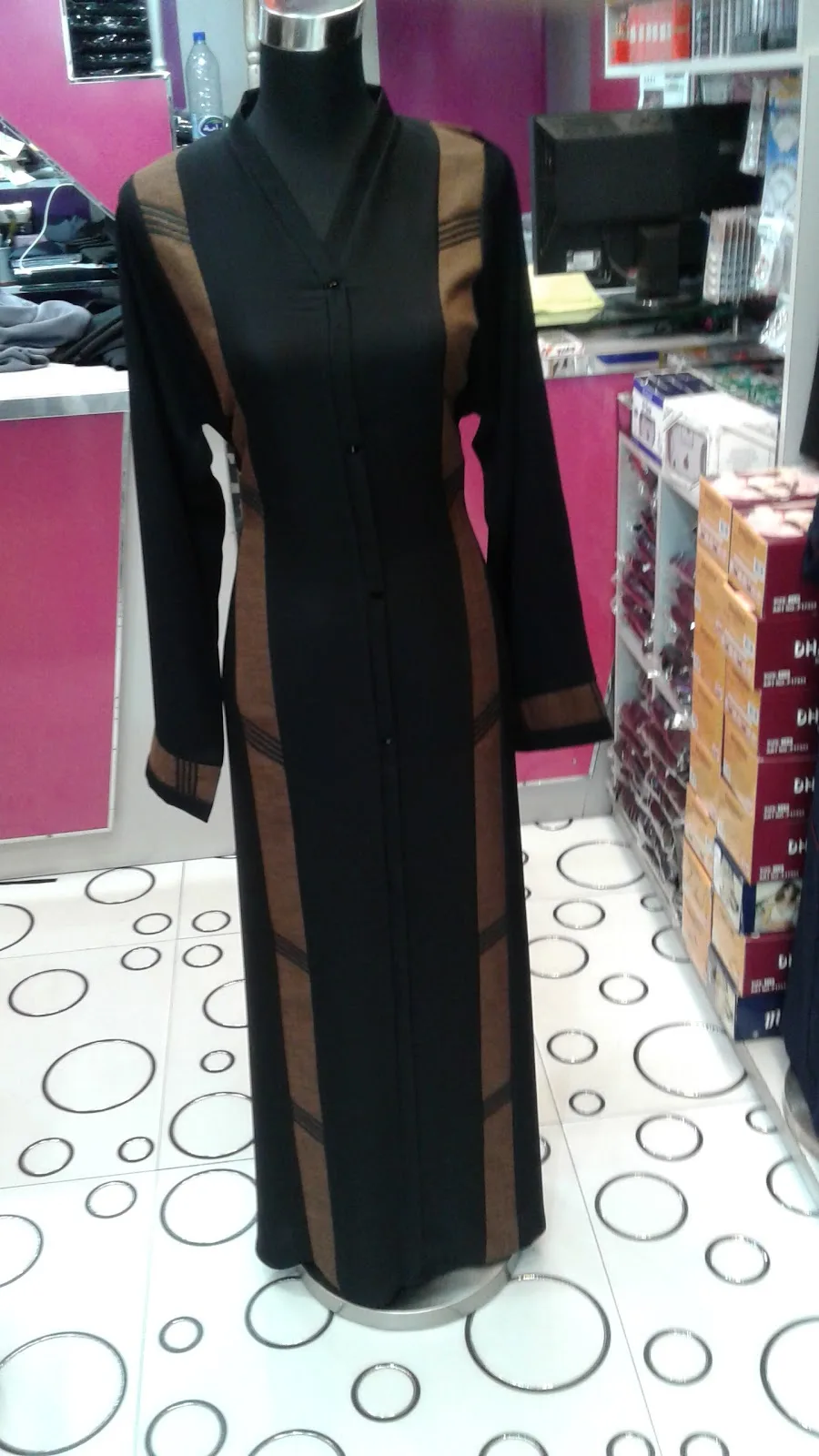 Black and tan panelled abaya on a mannequin