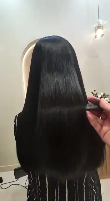 Long glossy black hair after a keratin smoothing treatment