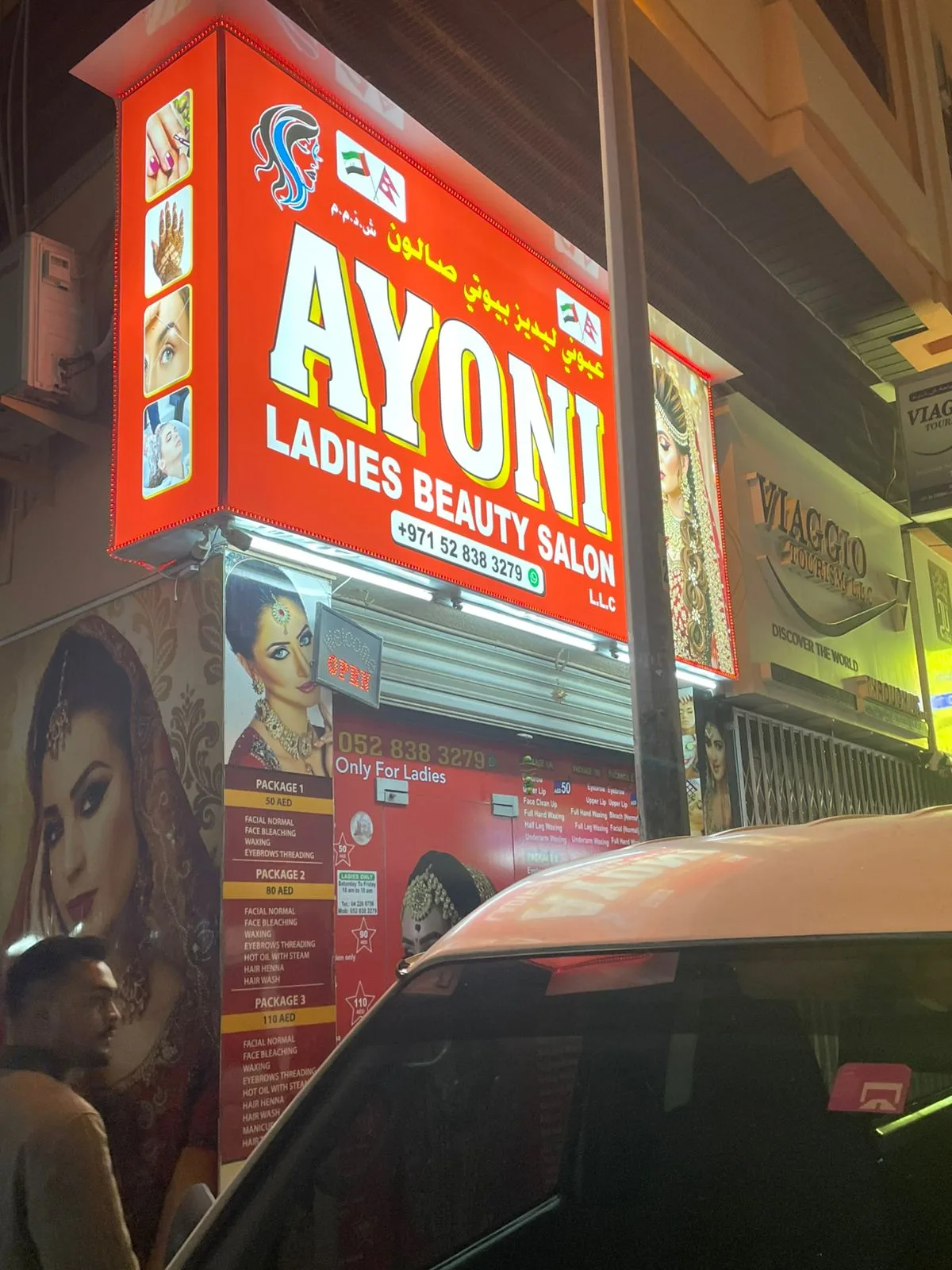 Illuminated Ayoni Ladies Beauty Salon shopfront sign at night in Deira