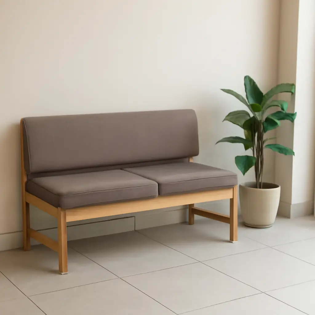 Cushioned waiting bench beside a plant