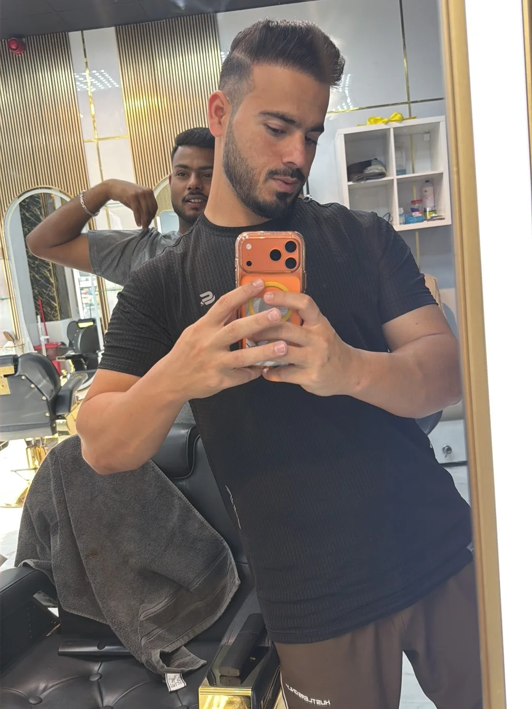A fresh gents haircut and beard trim at Noor Al Khaima — a textured top with a tight fade