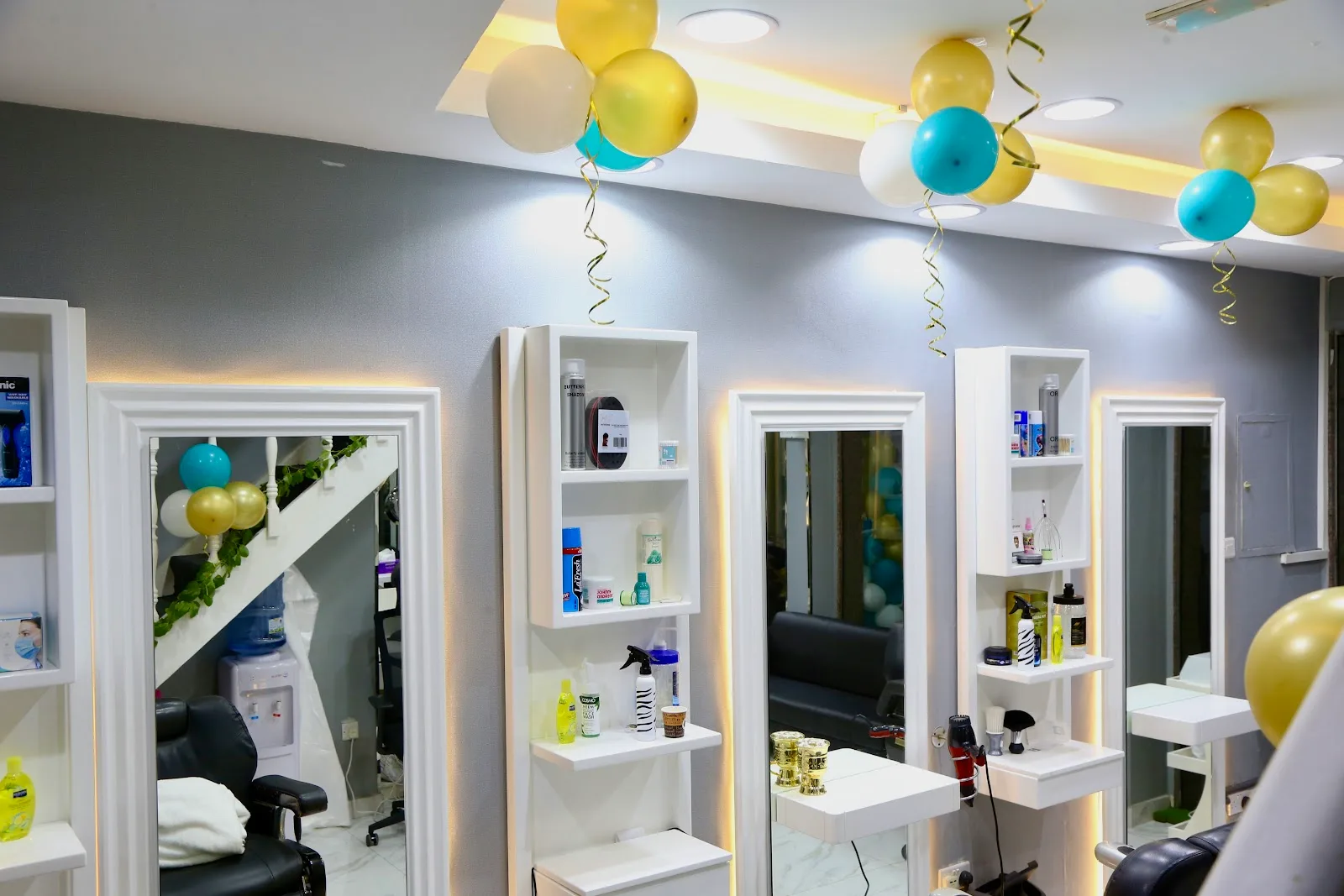 White-framed mirror stations and product shelves decorated with balloons for the opening