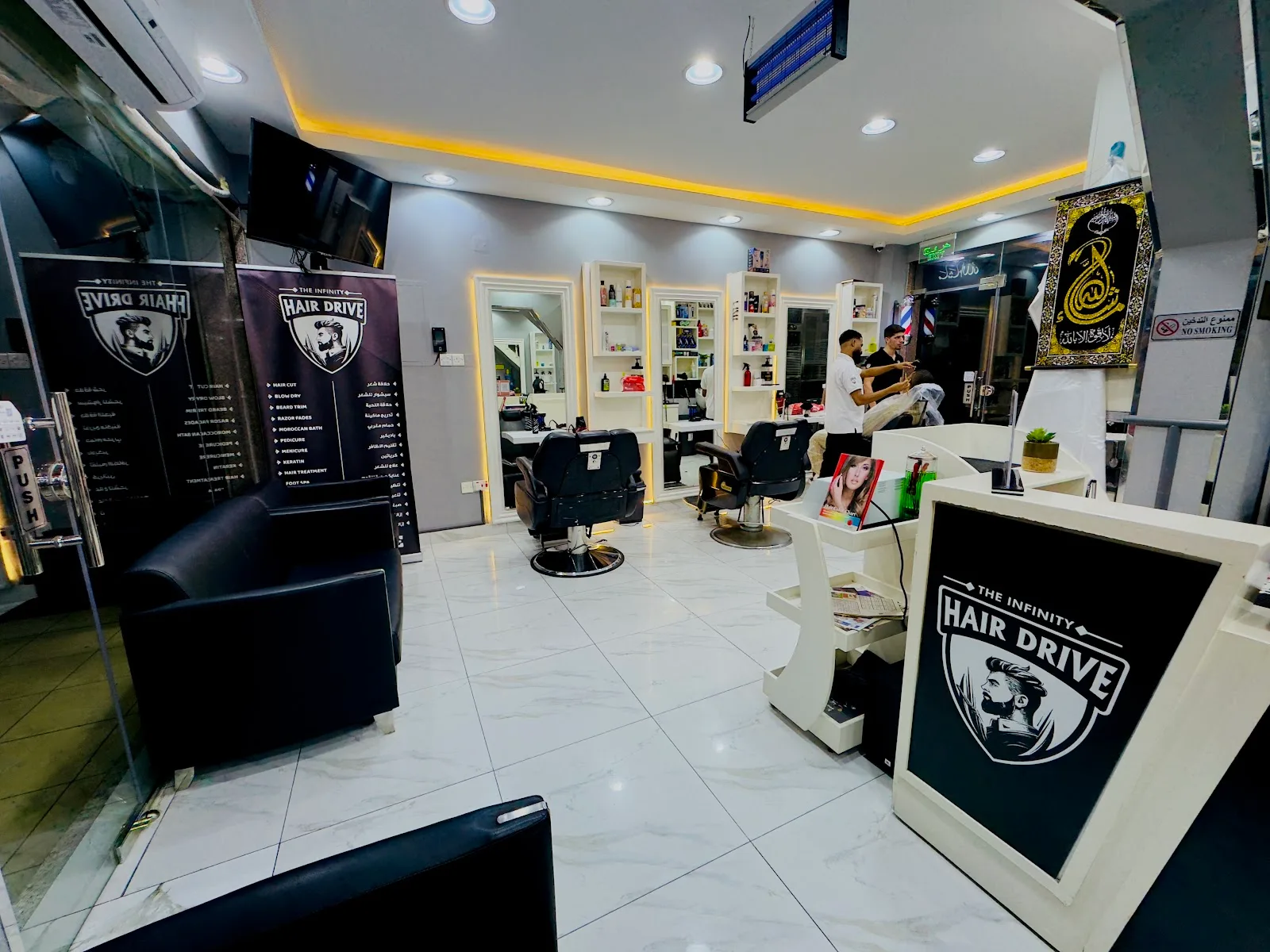 HAIR DRIVE barber chairs, service board and shield logo standee inside the salon